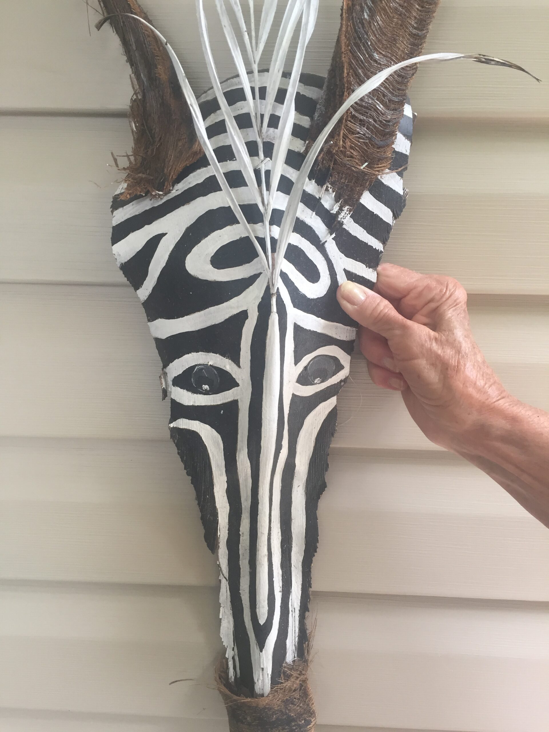 Zebra made from dried palm fronds and pieces